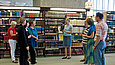 Participants in a library tour stand in front of bookshelves