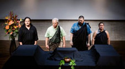 4 people in front of a table covered with black cloth