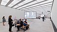 Die Sonderausstellungshalle ist ein länglicher fensterloser Raum mit weißen Wänden und ausgiebiger indirekter Beleuchtung