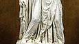 Two marble figures of women on a pedestal