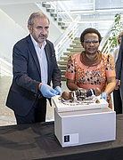 Ein Mann und eine Frau stehen hinter einem namibischen Objekt