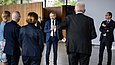 Ein Mann mit Mikrofon redet vor einer Personengruppe