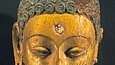 Partially gilded head of a Buddha with black hair