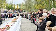 Personen stehen um eine lange gedeckte Tafel am Kulturforum