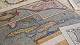 Multicolored maps of the world on a table