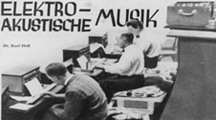 Black and white shot of three men sitting next to each other in front of electronic devices