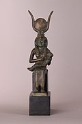 A bronze statuette of the god Osiris, wearing a high crown and with a mummy-shaped body.