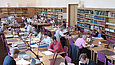 People sitting at desks in a reading room