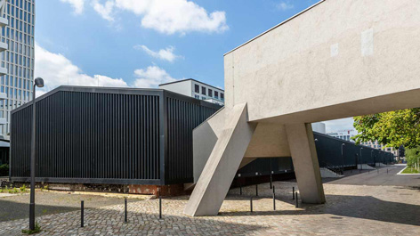 Zwei moderne Gebäude vor blauem Himmel