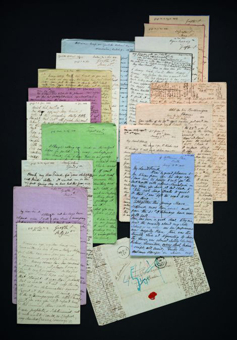 Historical letters, very neatly handwritten on paper in different colors.