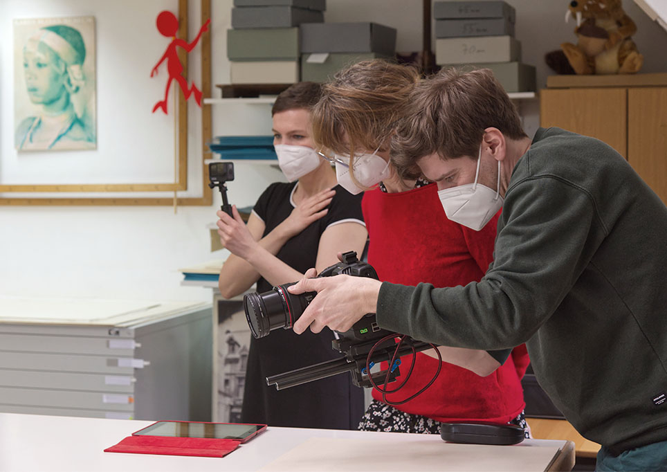 Films about various aspects of preservation work Three people are filming something
