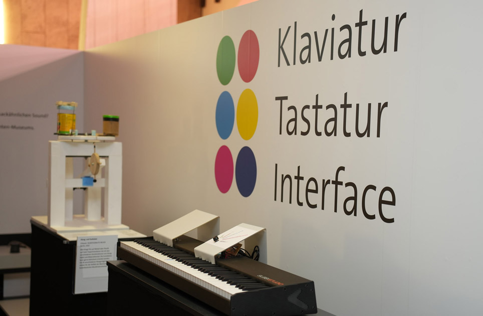 Klaviatur – Tastatur – Interface Blick in eine Ausstellung, an der Wand steht "Klaviatur – Tastatur – Interface"