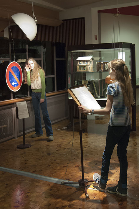 Rainforest Children try out a sound station at the museum.