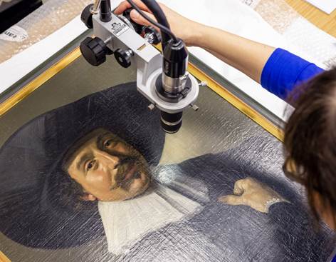 Painting by Frans Hals A woman examines a painting