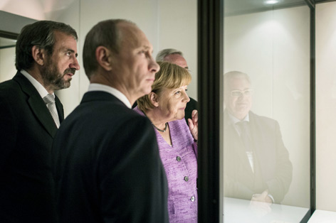 Im Juni 2013 wurde die Ausstellung „Bronzezeit – Europa ohne Grenzen“ von Bundeskanzlerin Angela Merkel und Präsident Wladimir Putin eröffnet. Sie war in St. Petersburg und Moskau zu sehen. © Bundesregierung / Denzel Menschengruppe blickt in Museumsvitrine