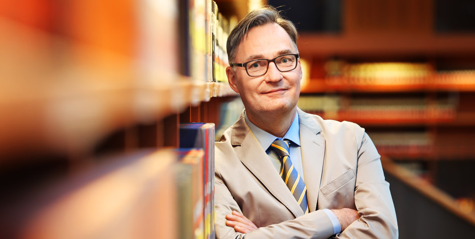 Portrait of a man in a library.