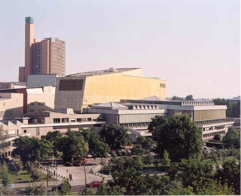 Modern buildings in a square behind trees