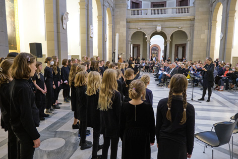 A girls choir sings in a church