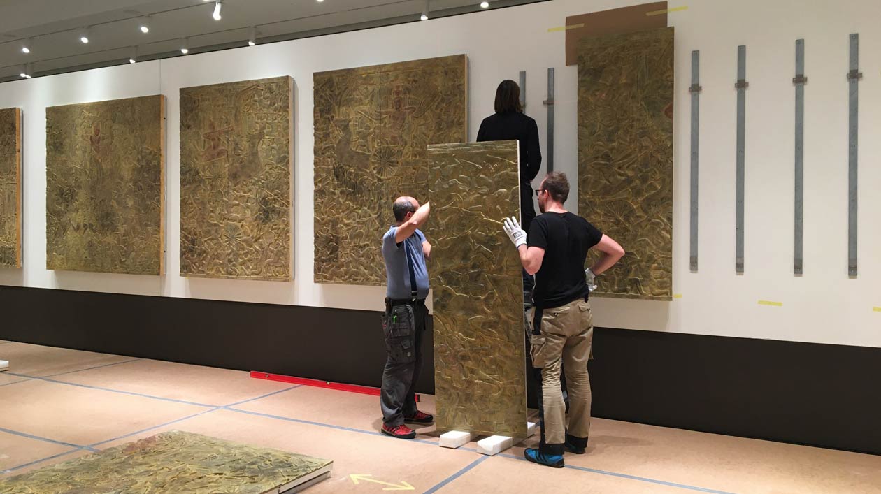 Exhibition setup in the Museum für Asiatische Kunst Two men in an exhibition hall
